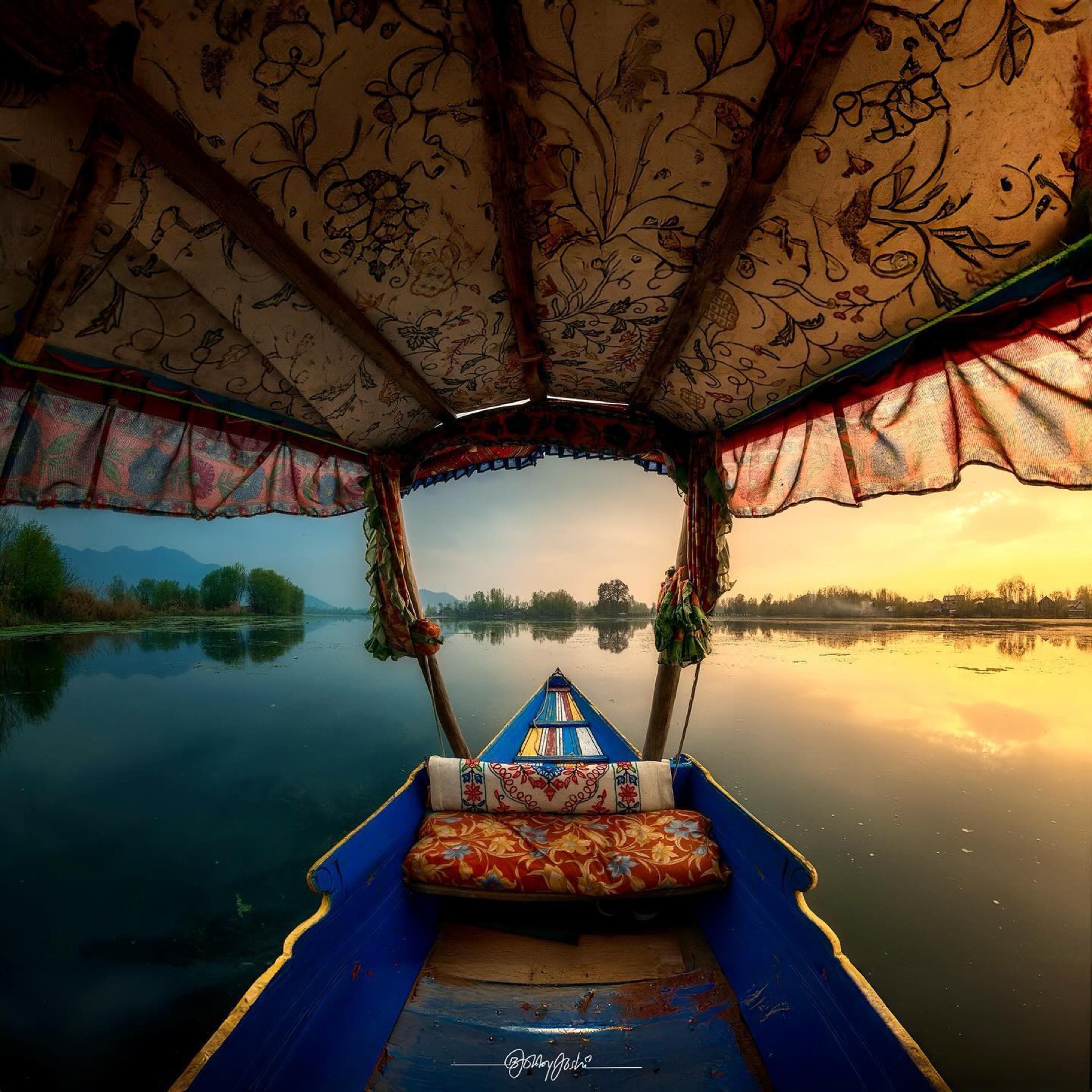 Kashmir shikara interior framing the lake at golden hour